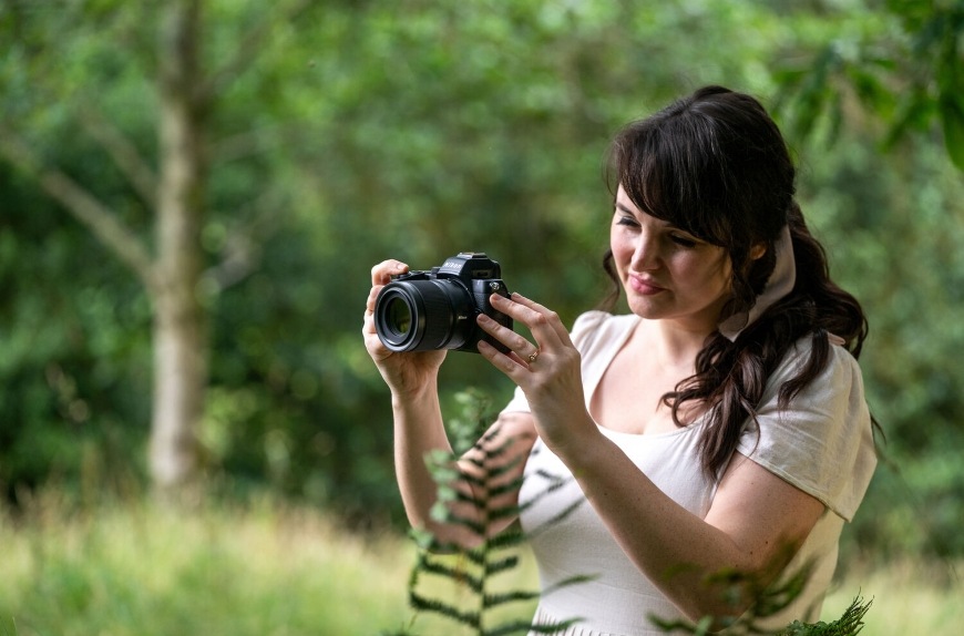 Žena fotografujúca s kompaktným objektívom NIKKOR Z DX MC 35 mm f/1.7