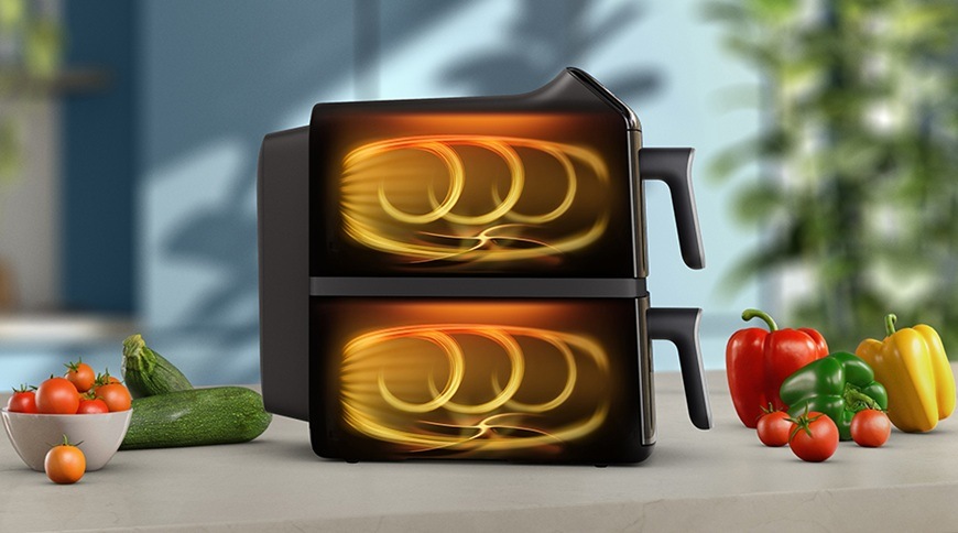 Fritéza teplovzdušná Philips Airfryer Dual Basket 4000 series 10 l, NA461/00 čierna Teplovzdušná fritéza Philips NA461/00 s dvoma košmi zobrazená z boku, s grafickým znázornením prúdenia horúceho vzduchu v oboch komorách, vedľa spotrebiča sú na kuchynskej linke čerstvá zelenina.