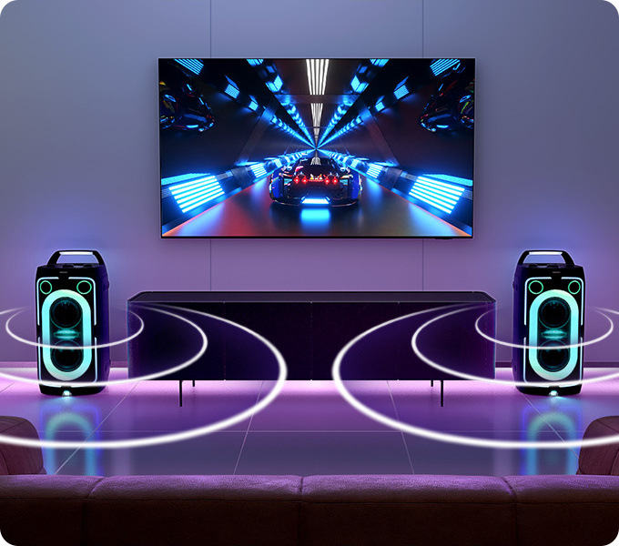 Dva reproduktory Samsung MX-ST40F sú umiestnené pod televíziou, krúžky vychádzajúce z oboch reproduktorov znázorňujú šírenie zvuku