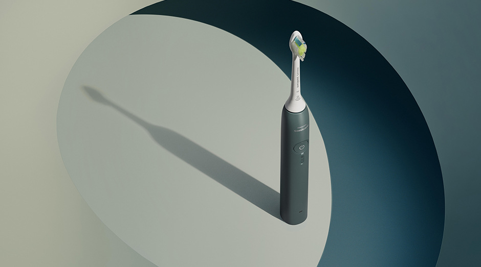 Zubná kefka Philips Sonicare 3100 HX4033/26 zelená Stojaca kefka Philips HX4033/26 Sonicare 3100 a za ňou tieň