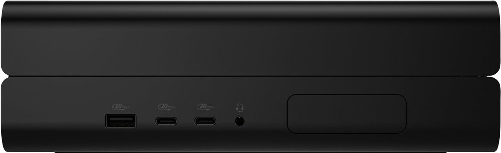 PC mini HP Z2 Mini G1i čierny Na obrázku je predný alebo bočný panel kompaktného stolného počítača HP Z2 Mini G1i v čiernom prevedení. Telo má nízky, široký tvar s jemne zaoblenými hranami a hladkým matným povrchom. Vľavo sú tri konektory na čelnej strane - jeden klasický USB port a dva USB-C porty - vedľa malý okrúhly audio konektor pre slúchadlá. Vpravo je väčší obdĺžnikový kryt alebo záslepka.