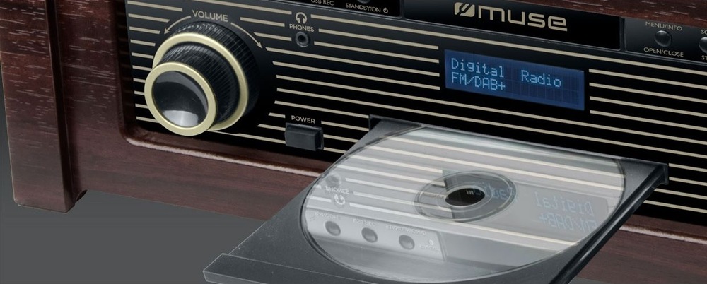 Gramofón MUSE MT-115DAB Retro gramofón Muse MT-115 DAB s vinylovou doskou na šedom stole v modernej obývacej izbe