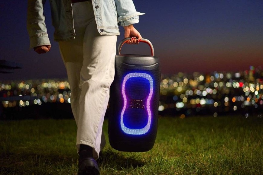 Osoba nesúca reproduktor PartyBox 130 s ergonomickým madlom