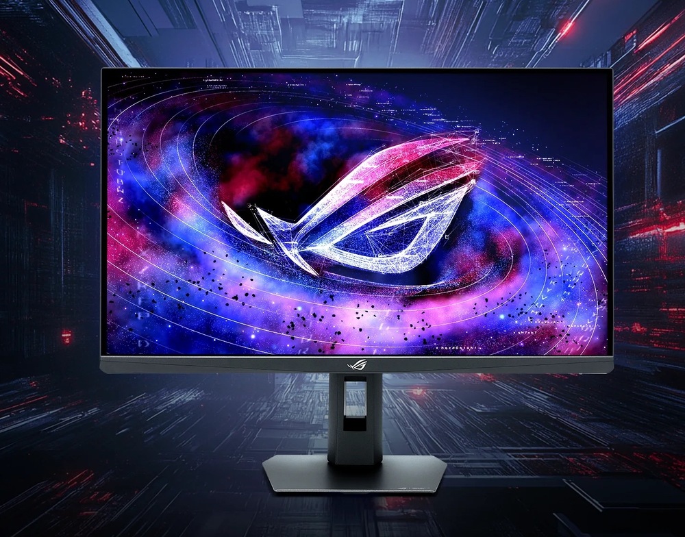 Herný monitor Asus ROG Strix XG27AQNGV čierny Na obrázku je herný monitor Asus ROG Strix XG27AQNGV 27" v čiernom prevedení. Monitor stojí na výškovo nastaviteľnom stojane s plochou hranatou základňou a otvorom pre vedenie káblov. Na obrazovke je výrazná vesmírna grafika s veľkým svietiacim logom ROG v modrých, fialových a ružových. herné zameranie monitora a výrazné farebné podanie displeja.