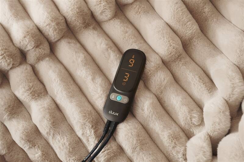 Vyhrievacia deka Duux DXOB02 Yentl Cuddle 200 x 200 cm sivá Ovládač deky s LED displejom a tlačidlami pre voľbu teplotných režimov a odpočítavanie času, napojený na textíliu dvoma ohybnými káblami, umiestnený na povrchu deky.