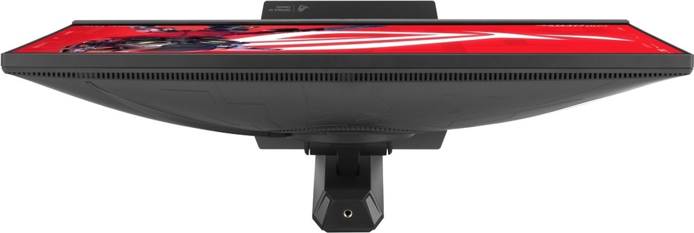 Herný monitor Asus ROG Strix XG248QSG Ace čierny Na obrázku je herný monitor ASUS ROG Strix z horného pohľadu. Je vidieť tenké telo displeja, horná hrana obrazovky s červenou grafikou a dlhá vetracia mriežka po celej zadnej časti. Uprostred vystupuje uchytenie stojana, ktoré monitor drží na výškovo nastaviteľnom podstavci. Zadný kryt má čierne prevedenie s jemným herným vzorom.