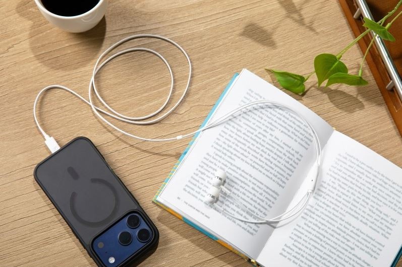 Slúchadlá Sennheiser CX80U biela Slúchadlá Sennheiser CX80U na obrázku s knihou a smartphone