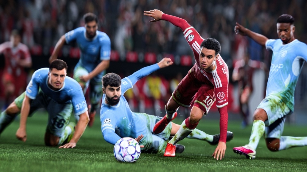 Futbalista v červenom drese si počas súťažného zápasu na zelenom trávniku vedie loptu okolo troch súperov v svetlo modrých dresoch.