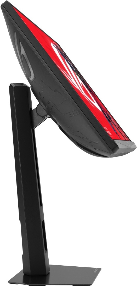 Herný monitor Asus ROG Strix XG248QSG Ace čierny Na obrázku je herný monitor ASUS ROG Strix z bočného pohľadu. Monitor je naklonený mierne dozadu, takže je dobre vidieť jeho tenké telo, čierny zadný kryt s herným vzorom a červená grafika na obrazovke. Displej drží robustný výškovo nastaviteľný stojan s hranatým stĺpikom a plochou základňou. Snímka ukazuje možnosť náklonu monitora a jeho štíhly profil z boku.