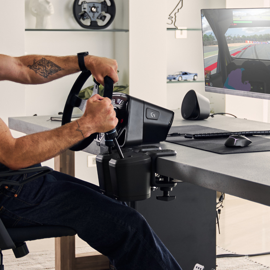 Logitech G RS Shifter & Handbrake upevnený k stolu vedľa závodného volantu