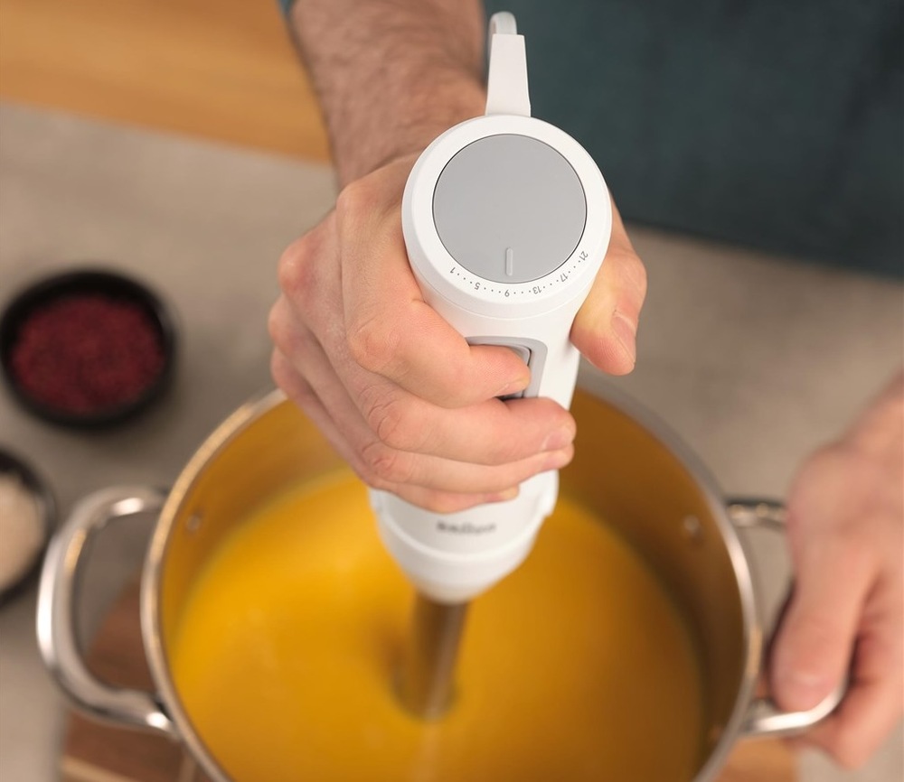Muž mixujúci tekvicovú polievku pomocou Braun MultiQuick 5″ width=