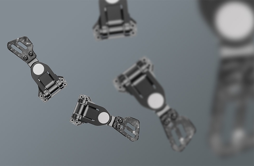 Pádla na radenie Moza Racing Paddles Add-on Kit čierne Vznášajúce sa čierne mechanické pánty s okrúhlymi striebornými prvkami na rozmazanom šedom pozadí, ktoré navodzujú dojem pohybu a modernosti.