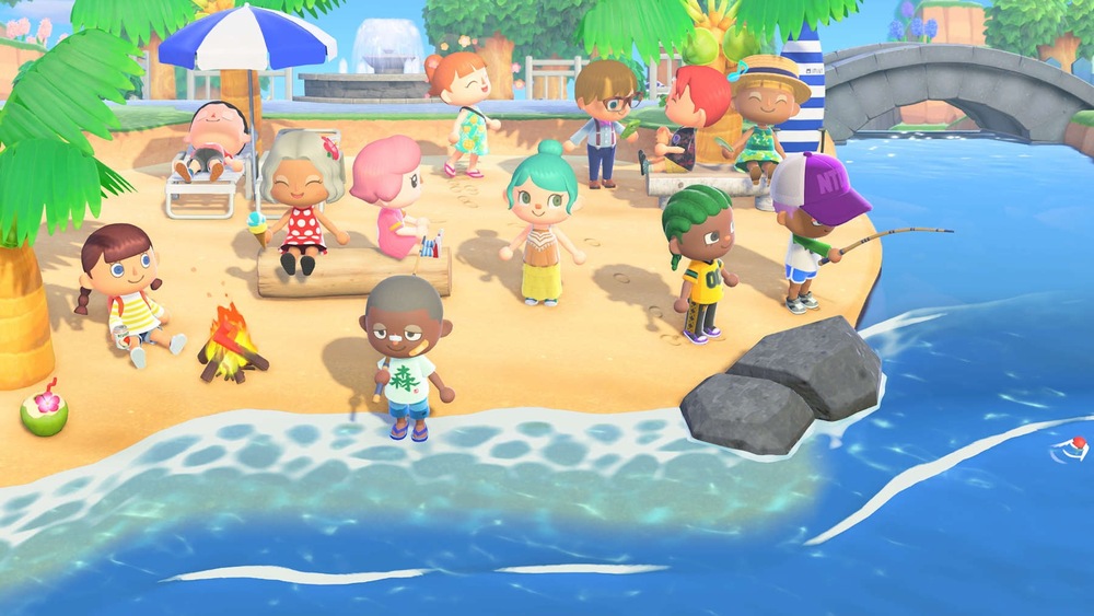 Záber z hry Animal Crossing: New Horizons. Živá plážová scéna zobrazuje postavy, ktoré odpočívajú, rozprávajú sa, rybárčia a leňošia pod slnečníkom, čím navodzujú radostnú atmosféru spoločenstva.