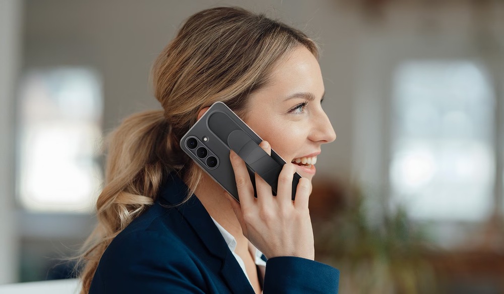 Kryt na mobil Samsung Standing Grip na Galaxy S25 FE tmavo modrá farba Kryt na mobilný telefón Samsung Galaxy S25 FE - žena držiaca telefón v kryte Samsung Standinf Grip v čiernom prevedení