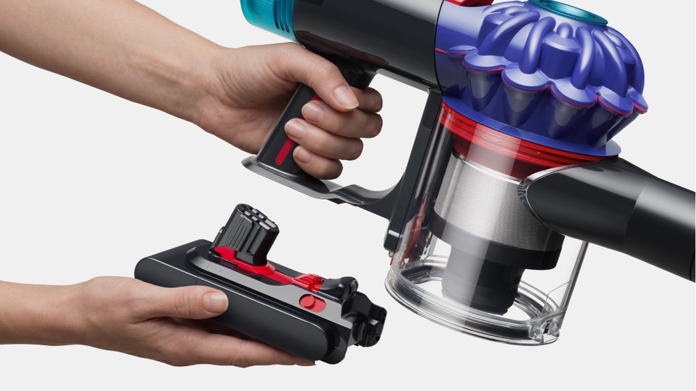 Pohľad na ruky držiace batériu pre tyčový vysávač Dyson V10 Konical
