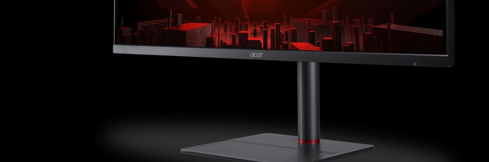 Herný monitor Acer Nitro XV345CURX čierny Záber na herný monitor s futuristicky vyzerajúcim mestom na obrazovke pred čiernym pozadím.