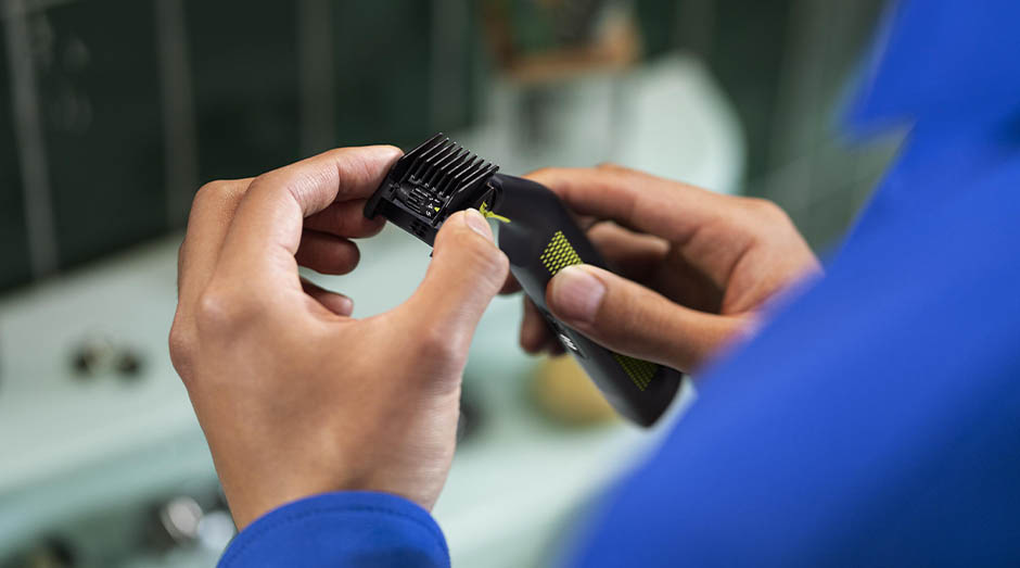 Zastrihávač fúzov Philips OneBlade Pro QP6506/15 čierny Muž nasadzuje na zastrihávač Philips QP6506/15 OneBlade Pre hrebeňový nástavec