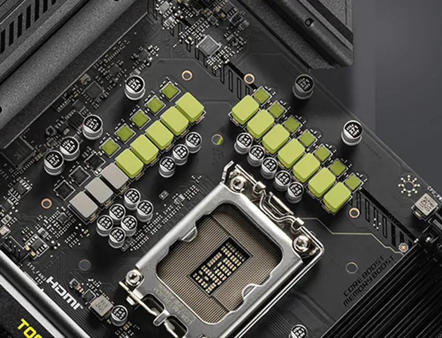 Základná doska MSI MAG B860 TOMAHAWK WIFI Detail počítačovej základnej dosky s päticou pre procesor obklopenou radmi kondenzátorov a svetlo zelenými chladičmi.