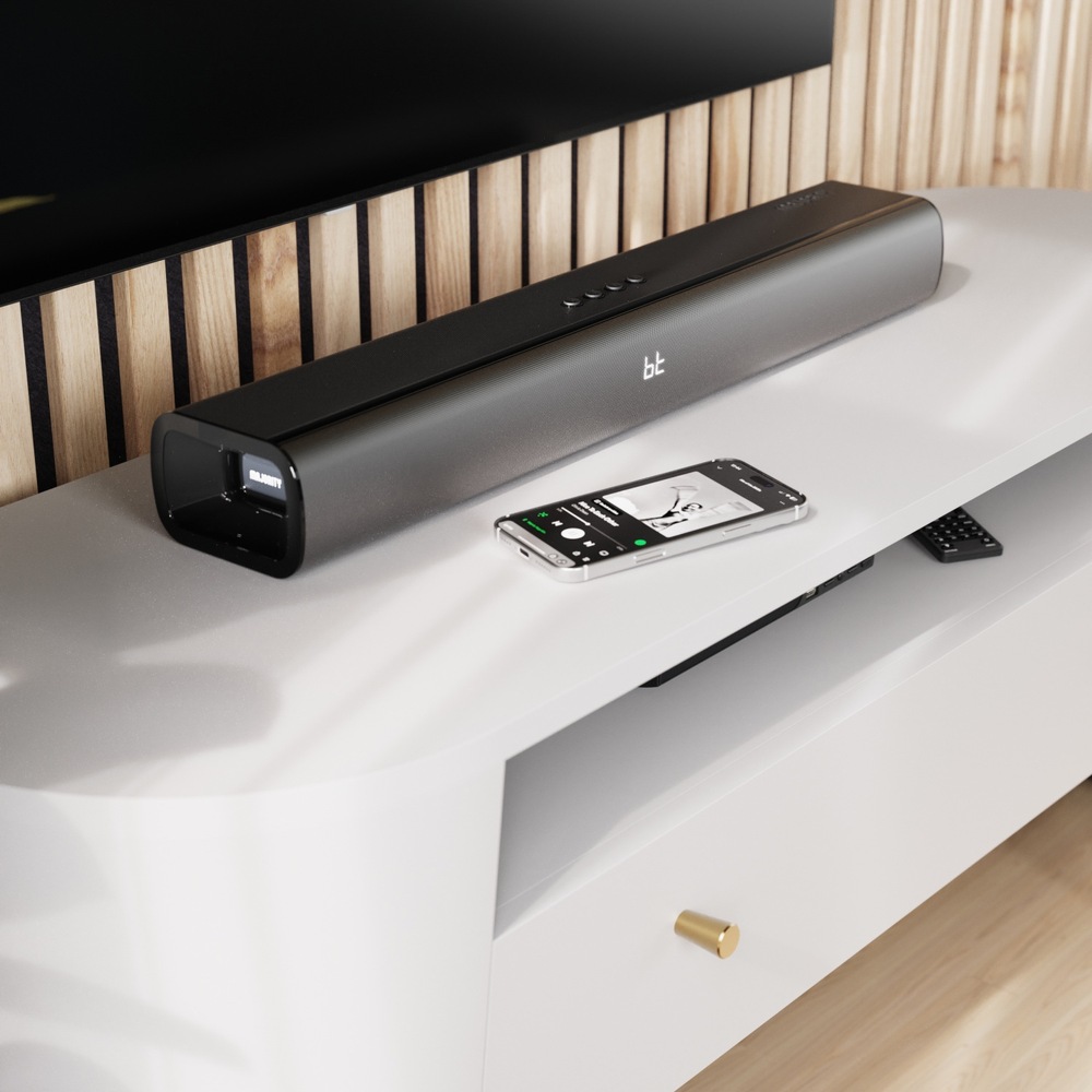 Soundbar Majority Naga 60 Plus umiestnený pod televízorom, bezdrôtovo prehrávajúci hudbu z telefónu.