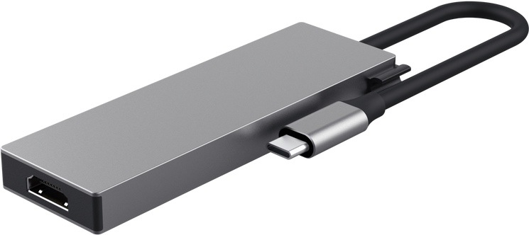 USB Hub Trust DALYX 5v1 strieborný Na obrázku je strieborný USB-C hub Trust DALYX 5v1 zachytený zozadu a mierne z boku. Má úzke kovové telo s čistým hranatým designom, na ľavom čele je vidieť HDMI konektor. Z druhej strany vychádza krátky pevný kábel zakončený USB-C konektorom na pripojenie k notebooku alebo tabletu. Z