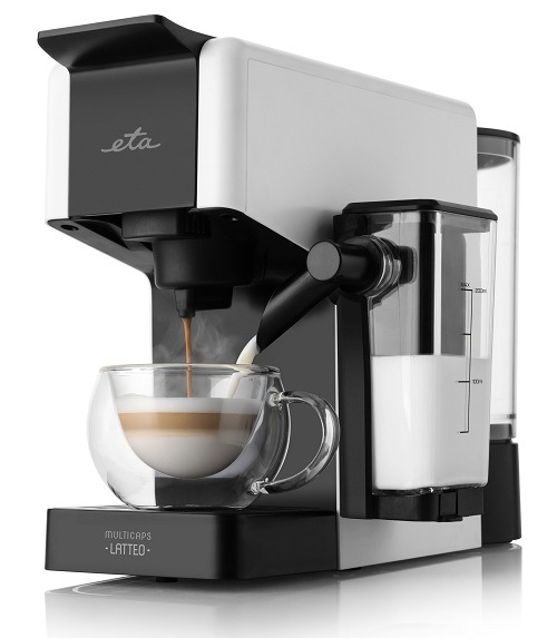 Biely kapsulový kávovar ETA Multicaps Latteo pripravujúci cappuccino do priehľadnej šálky