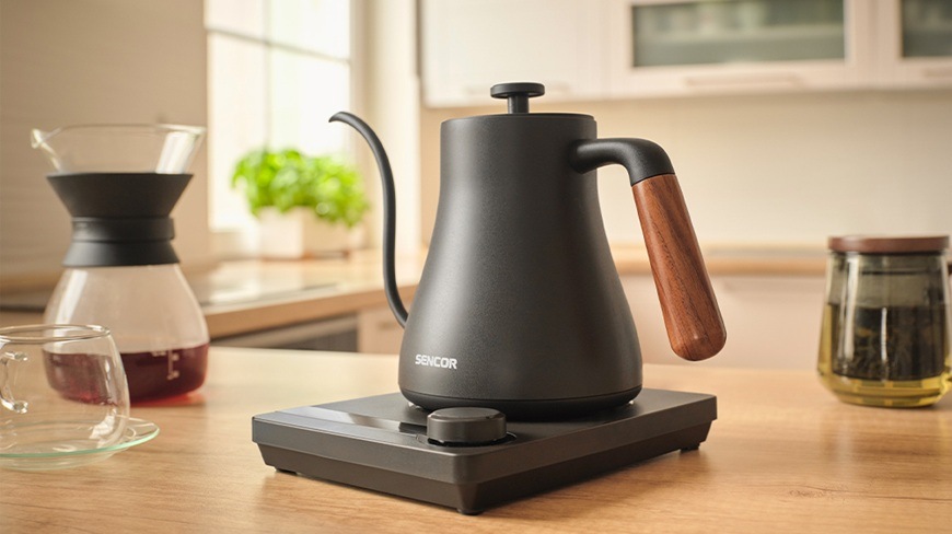 Rýchlovarná kanvica Sencor SWK 2828BK, 0,6 l čierna Bočný pohľad na rýchlovarnú kanvicu Sencor SWK 2828BK, ktorá stojí v základni na kuchynskej linke v modernej kuchyni.