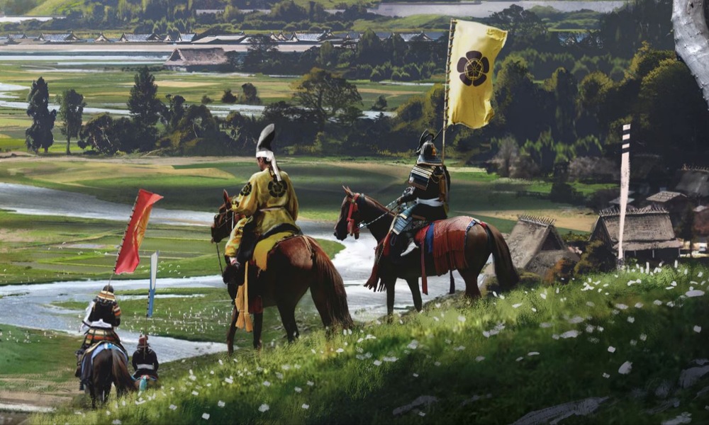 Obrázok z hry Assassin's Creed Shadows. Záber na postavy na koňoch, schádzajúci z kopca do údolia s japonskou dedinou v pozadí.